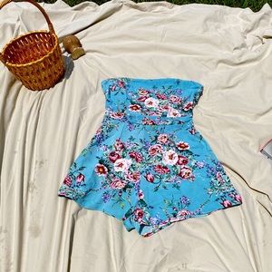 Blue floral romper/jumper with spaghetti straps.